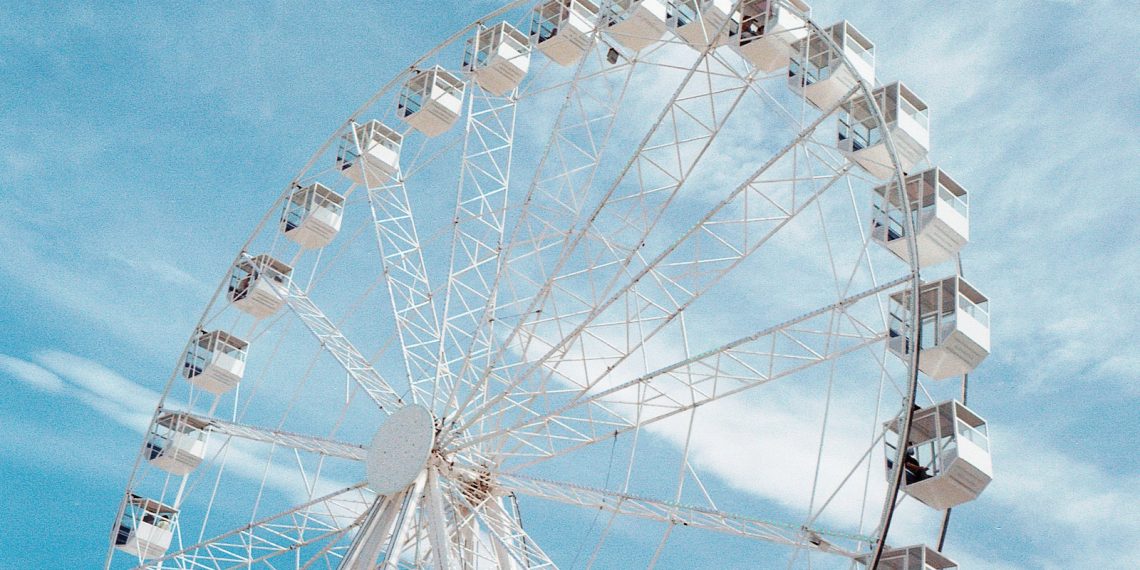 a large ferris wheel sitting under a blue sky