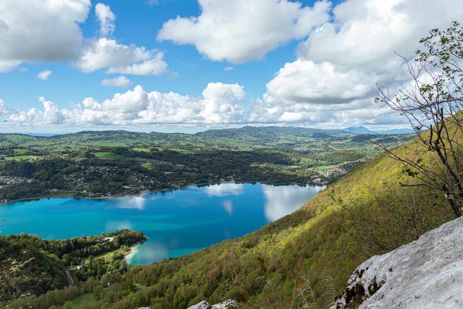 a lake surrounded by hills and trees